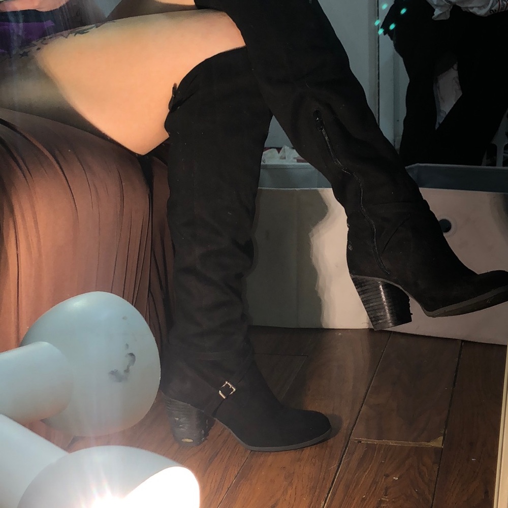 Knee high black boots. Good condition. Black strap for tightening upper leg